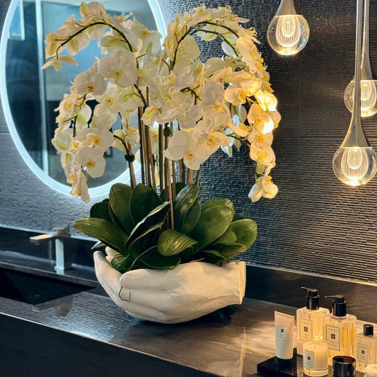 White Phalaenopsis Orchids in Vase with Sculpture "Open Hands"